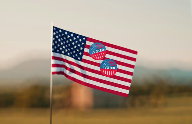 American flag with I Voted stickers on it. 