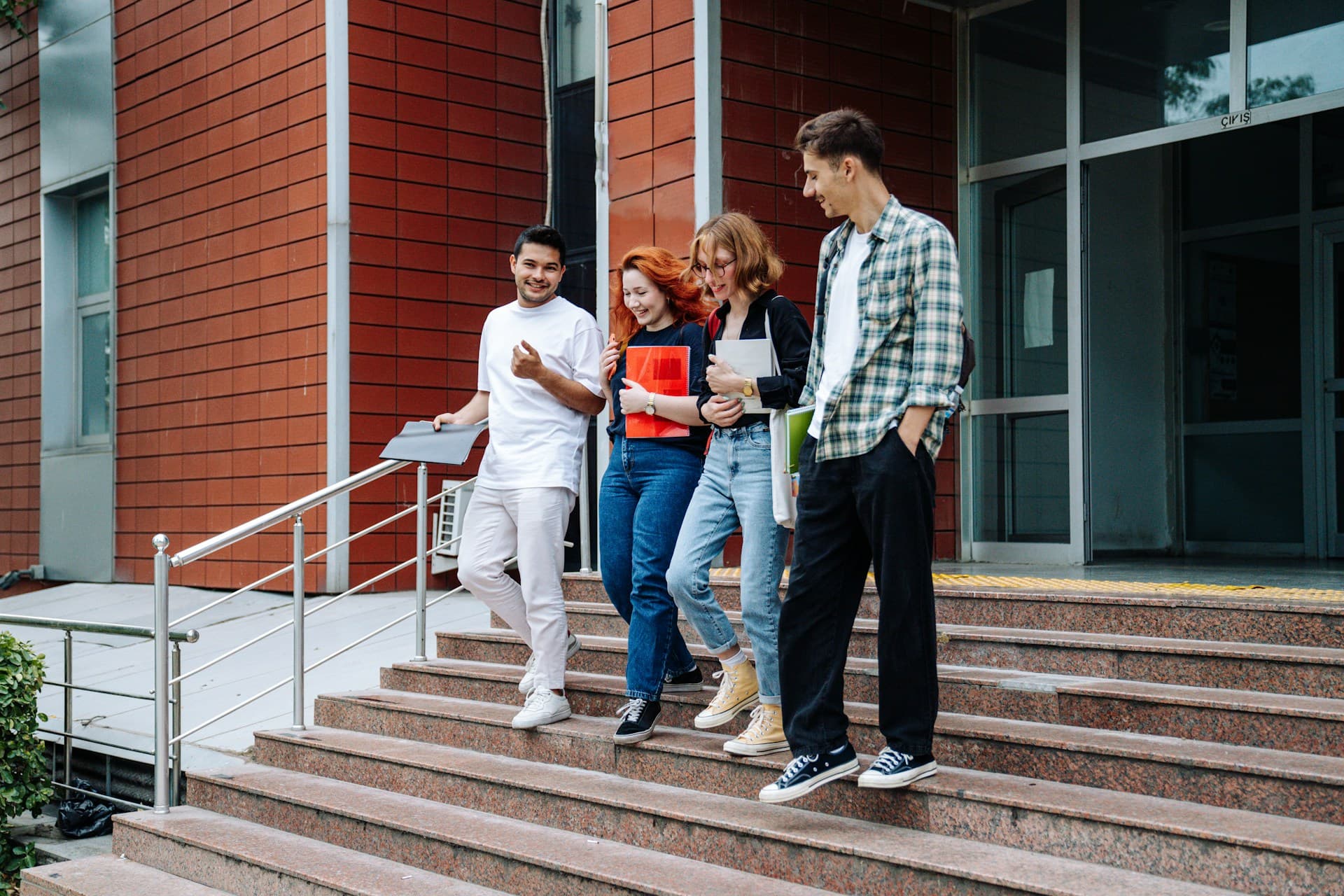 Young people standing on stairs. 