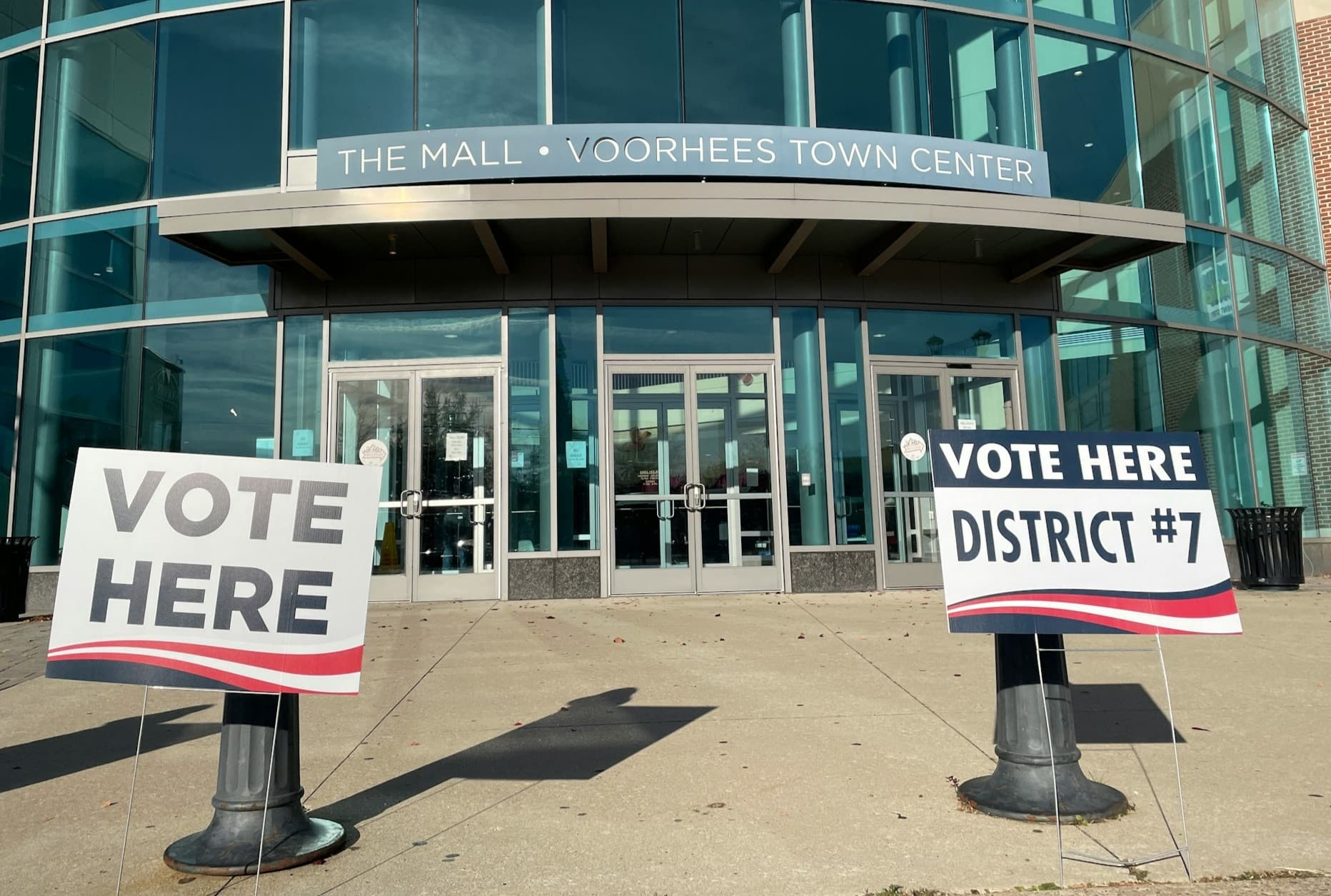 Vote here signs outside a building. 